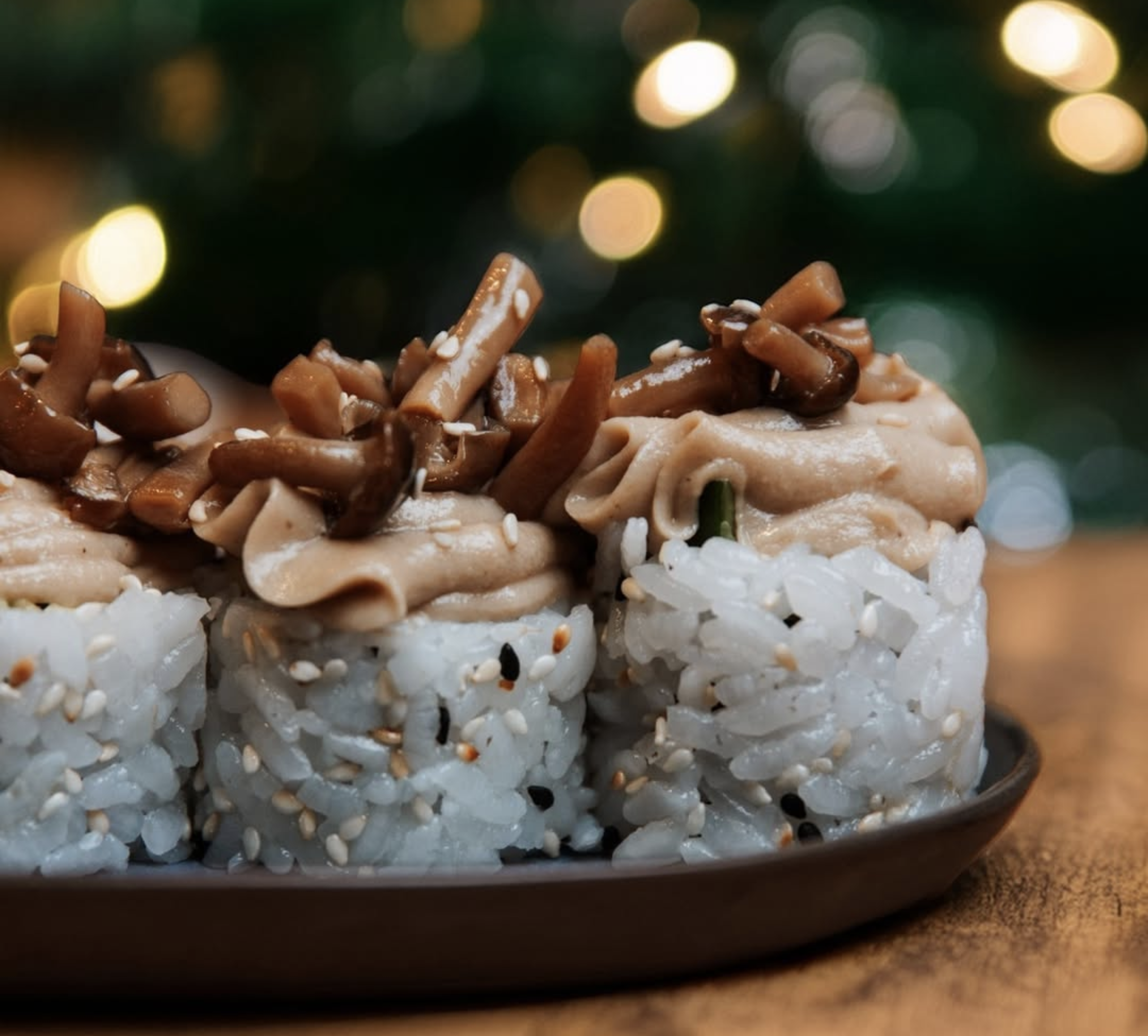 Vegan sushi rolls topped with mushrooms and sesame at Youmiko in Kraków